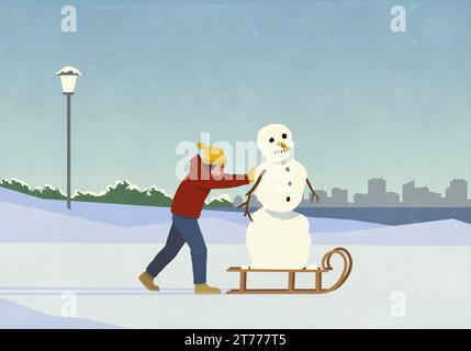 Femme poussant le bonhomme de neige sur le traîneau dans le parc enneigé de la ville d'hiver Banque D'Images