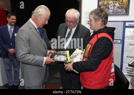 Le roi Charles III, achète une copie de The Big issue au vendeur Kelvin avec Lord John Bird, le fondateur de The Big issue, au lancement du Coronation Food Project, qui vise à combler le fossé entre le gaspillage alimentaire et les besoins alimentaires dans les quatre nations du Royaume-Uni, au centre de distribution de surplus de nourriture de South Oxfordshire Food and Education Alliance (SOFEA), à Didcot, Oxfordshire. Date de la photo : mardi 14 novembre 2023. Banque D'Images