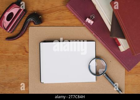 Loupe de livres empilés près du cahier Banque D'Images