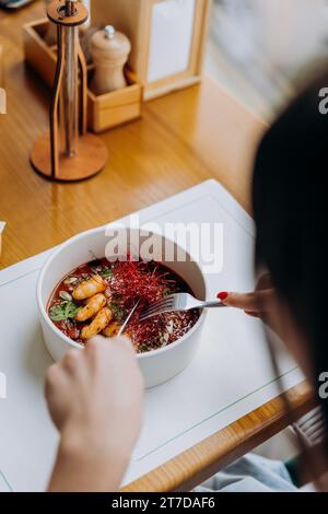 Gros plan de femme mangeant de la nourriture thaïlandaise de porridge de citrouille avec des crevettes dans le restaurant Banque D'Images