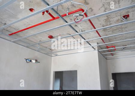 Système de conduit et tuyaux d'incendie automatiques à l'intérieur du processus de la maison de plafond dans le chantier de construction. Banque D'Images