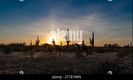 Hunter Cooley et Zach Libby ride au coucher du soleil, White Stallion guest ranch, Marana, Arizona Banque D'Images