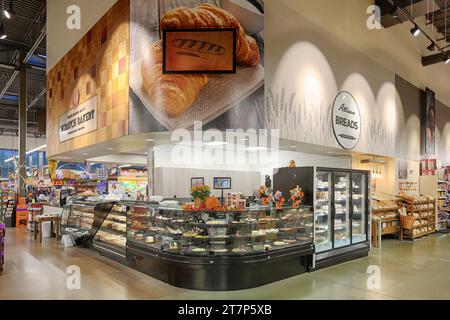 Un kiosque spécialisé à l'intérieur d'un supermarché moderne, servant du café, de la crème glacée et des produits de boulangerie, Banque D'Images