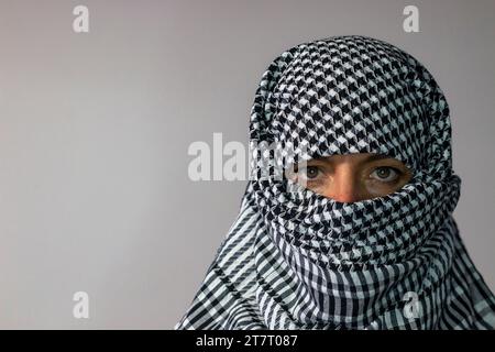 Femme aux yeux verts portant une écharpe palestinienne. Concept de conflit Banque D'Images