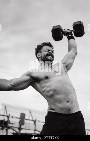 Compétition CrossFit pour Homme. Un homme soulève un haltère. Banque D'Images