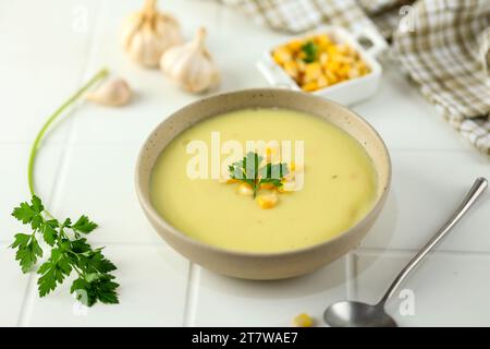 Délicieuse soupe de maïs crémeuse servie sur une table blanche, Close Up Banque D'Images