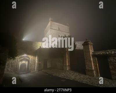 La tour et la porte d'un château médiéval dans une petite ville pendant une nuit d'hiver avec brouillard, Castello di Seravalle, Emilie Romagne, Italie, Europe Banque D'Images