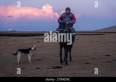 Camp de yourtes sur le lac Song Kul au Kirghizistan Homme local à cheval Banque D'Images