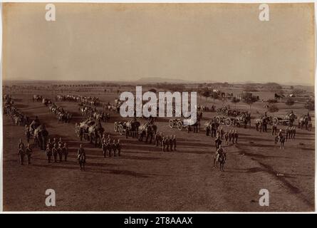 Les exercices impliquant des batteries d'éléphants, exotiques aux yeux des Européens, attiraient les spectateurs ; les photographies d'entre eux étaient d'excellents souvenirs de ces forces militaires employées par l'armée indienne britannique. Les éléphants avaient été employés dans la guerre en Inde depuis au moins les années 500 av. J.-C., mais avec l'avènement de l'artillerie lourde, leur fonction est passée de l'attaque à l'appui. Ils transportaient de grosses armes et des fournitures et travaillaient dans l'exploitation forestière et la construction. Il a fallu beaucoup de bétail pour tirer une charge qui pouvait être manipulée par deux éléphants. Batterie éléphant sur Parade, 1886. Raja Deen Dayal (Indien, 1844-1905). Albume Banque D'Images