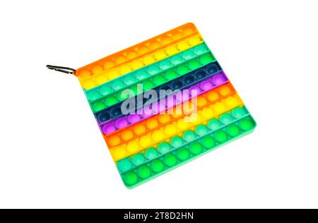 Pastel Color Sensory POP IT jouet antistress pour les enfants. jouet en silicone arc-en-ciel sur fond blanc. Banque D'Images