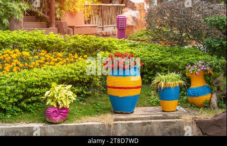 vase en argile coloré avec fleur dans le jardin Banque D'Images