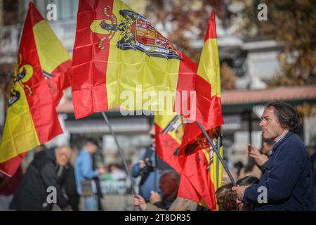 Madrid, Espagne. 19 novembre 2023. Un homme tient un drapeau pré-constitutionnel espagnol lors de l'événement annuel contre la loi sur la mémoire démocratique appelé par le «mouvement catholique espagnol», une organisation ultra-catholique et d'extrême droite sur la Plaza de Oriente. Ils ont également protesté contre la loi d'amnistie en faveur des politiciens indépendantistes catalans par le président élu Pedro Sanchez. Crédit : SOPA Images Limited/Alamy Live News Banque D'Images