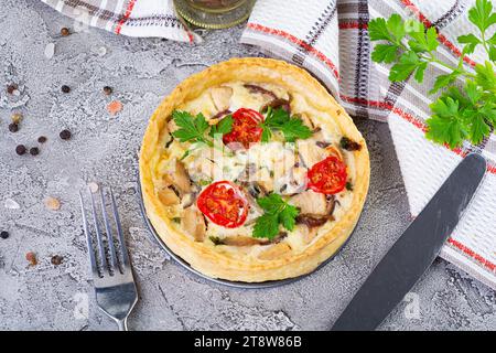 Délicieuse quiche avec du poulet, des champignons, des tomates et des herbes Banque D'Images