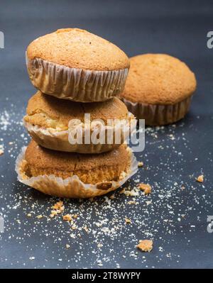 Cupcakes savoureux un aliment sucré, frais de gâteau de tasse dans le fond noir. Banque D'Images