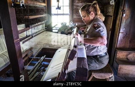 Park ranger démontre l'utilisation d'un métier à tisser à main pour fabriquer du tissu, Mabry Mill, Blue Ridge Parkway, Virginie, États-Unis Banque D'Images