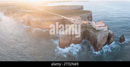 Un sommet les falaises accidentées de Cabo de São Vicente, Farol do Cabo de São Vicente phare, vue panoramique sur l'océan Atlantique. Région de l'Algarve. Antenne Banque D'Images