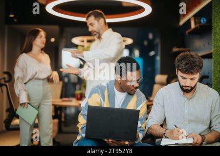 Groupe multiracial de professionnels discutant des affaires et analysant le marché dans l'espace de travail moderne du centre-ville Banque D'Images