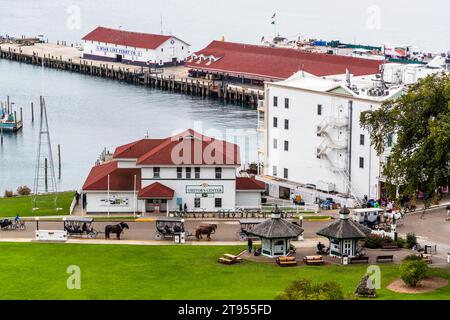 Vue sur le port et le centre d'accueil de l'île Mackinac depuis Fort Mackinac. Des calèches attendent sur la route principale pour emmener les touristes autour de l'île. Mackinac Island, Michigan, États-Unis Banque D'Images