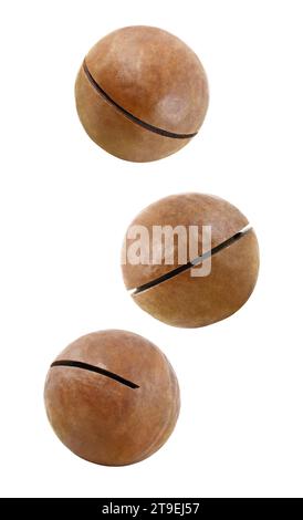 Noix de macadamia entières trois, tomber, voler, monter en flèche, isolé sur un fond blanc avec chemin de détourage. Profondeur de champ totale. Banque D'Images