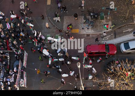 Seattle, États-Unis. 25 novembre 2023. Des manifestants pro-Palestine marchent sur Pine Street avec des cercueils de fortune. Des militants se rassemblent depuis des semaines pour perturber la circulation et les achats en appelant à un cessez-le-feu à Gaza. Des rassemblements et des manifestations ont eu lieu dans le monde entier après le récent chaos qui a englouti Gaza. Crédit : James Anderson/Alamy Live News Banque D'Images