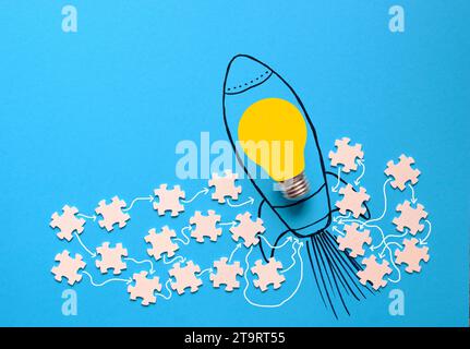 Concept d'entreprise, travail d'équipe rend le travail de rêve, coopération, innovation, ressources humaines, recrutement, idées avec ampoule, fusée et pièces de puzzle Banque D'Images