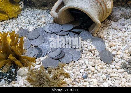 De vieilles pièces de monnaie renversées d'un pot d'argile sur le fond marin Banque D'Images