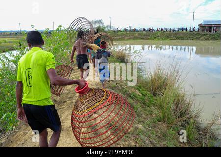 Non exclusive : 28 novembre 2023 Sylhet-Bangladesh : les populations rurales armées de pièges à poissons en bambou et filet prennent part à la célébration dans un hiver de 200 ans f Banque D'Images