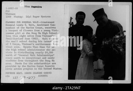 Le lieutenant général Lewis W Walt, commandant adjoint du corps des Marines, reçoit des fleurs d'une jeune fille vietnamienne à l'école secondaire de Dong Ha en 1969. Walt visita l'école lors de sa visite du Ier corps, la zone tactique nord du Vietnam. L'administrateur de l'école aide à distribuer des «bourses générales Walt» aux étudiants dans le besoin. Les bourses sont financées par le programme d'action civique de la Réserve des Marines. Ministère de la Défense photo (Marine corps) A192831. Banque D'Images