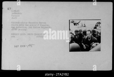 L'acteur vétéran Charlton Heston rend visite à la compagnie F du 204e bataillon du 9e régiment de Marines pendant les conflits au Vietnam. Cette photographie, prise en janvier 1966, montre Heston s'engageant avec les troupes. Il capture un moment important de soutien et de divertissement fourni au personnel militaire américain pendant la guerre. Banque D'Images