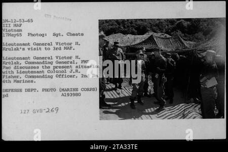 Le lieutenant-général Victor H. Krulak, commandant général de la FMF PAC, visite le 3e MAF pendant la guerre du Vietnam. On le voit discuter de la situation actuelle avec le lieutenant-colonel J.R. Fisher, officier de compactage, 2nd BN 4th Marines. Cette photographie montre des officiers et des fonctionnaires de 1965, dont Robert McNamara, Richard Nixon et Billy Graham. Banque D'Images