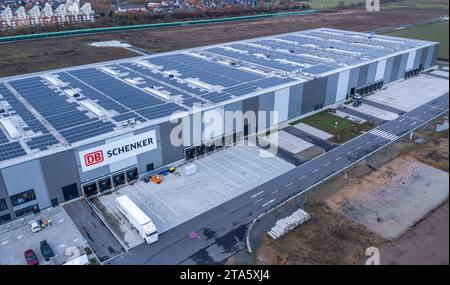 Rostock, Allemagne. 21 novembre 2023. Un camion se tient devant le bâtiment avec le nouvel entrepôt à baies hautes de la société de logistique DB Schenker. (Vue aérienne avec un drone) la filiale logistique de Deutsche Bahn exploite plusieurs centres logistiques dans le Mecklembourg-Poméranie occidentale. Crédit : Jens Büttner/dpa/Alamy Live News Banque D'Images