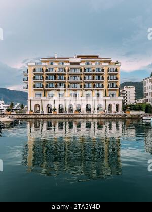 Le Regent Hotel se reflète dans la mer avec en toile de fond les montagnes. Porto, Monténégro Banque D'Images