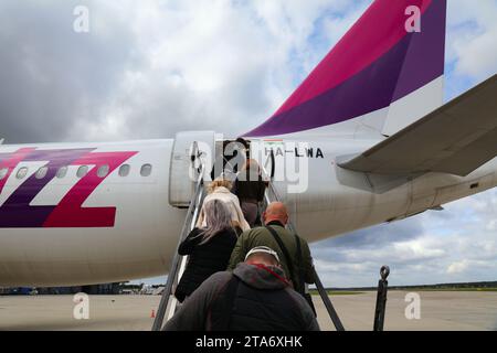 KATOWICE, POLOGNE - 24 SEPTEMBRE 2021 : les passagers montent à bord d'un Airbus A320 de la compagnie aérienne low cost Wizz Air par escalier à l'aéroport de Katowice en Pologne. Banque D'Images