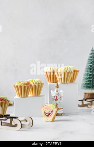 mini gâteaux à la crème de noël sur un fond clair dans des tartelettes sablées. Photo de haute qualité Banque D'Images