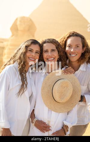 Mère, fille et fils latins, avec sphinx et pyramide derrière, Egypte Banque D'Images