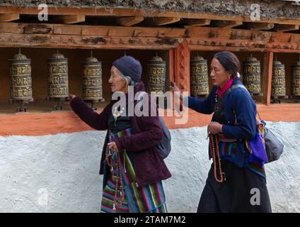 Les pèlerins tournent des roues de prière au monastère de Lo Gekar dans le village de Ghar, le plus ancien gompa bouddhiste au Népal, construit par Guru Rimpoche au 8e siècle - Mus Banque D'Images