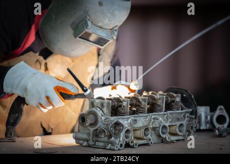 Le soudeur soud le soudage au gaz inerte au tungstène, soudant l'aluminium avec de l'argon en aluminium, torche de soudage TIG. Banque D'Images