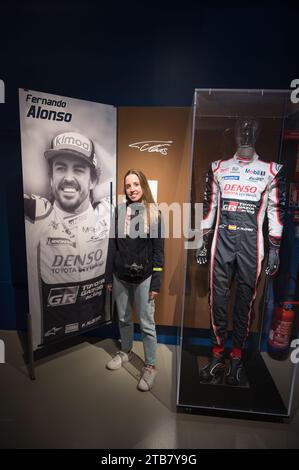 Une jeune fille qui est fan de Fernando Alonso prend une photo avec son affiche et sa signature à côté de son costume ignifuge Banque D'Images