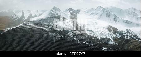 Vue panoramique aérienne de la mine d'or Kumtor au Kirghizistan, région d'Issyk-Kul. Camions à benne basculante avec du minerai d'or sur la route Banque D'Images