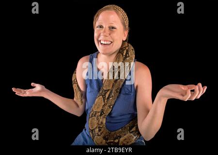 Une jeune femme tient un boa constrictor à queue rouge, Boa constrictor constrictor ; Lincoln, Nebraska, États-Unis d'Amérique Banque D'Images