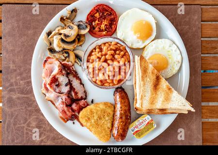 Une image de vue d'oiseau en gros plan d'un petit déjeuner anglais frit complet sur une table en bois. Banque D'Images