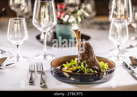 Gigot d'agneau confit sur purée de pommes de terre avec chou frisé crémeux, sauce demi glace et herbes au restaurant de l'hôtel. Banque D'Images