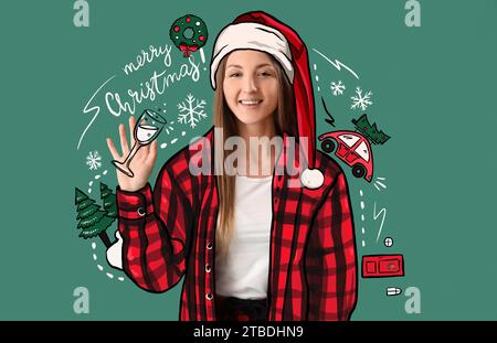 Jeune femme dans le chapeau de Santa et dessiné des symboles de Noël sur fond vert Banque D'Images