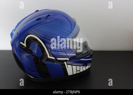 Casque de moto dans une couleur bleue, noire, blanche sur un fond gris Banque D'Images