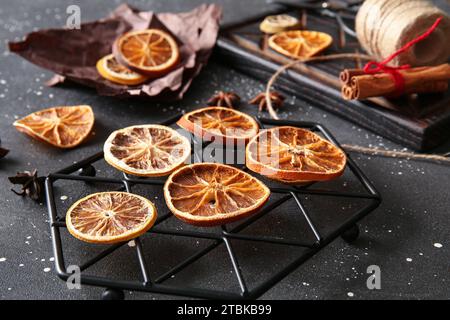 Stand avec des tranches d'orange séchées sur fond noir Banque D'Images