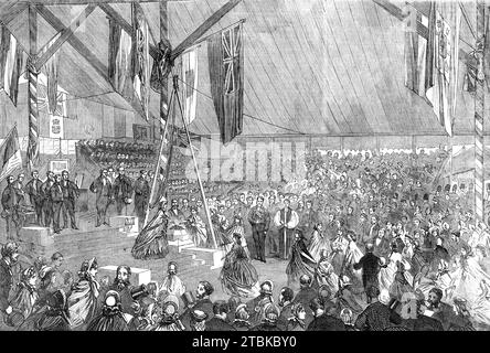 Pose de la première pierre de l'asile orphelin des marins marchands, par le Prince Consort : Ladies plaçant des sacs à main sur la pierre, [à Snaresbrook à Londres], 1861. « Le pavillon spacieux qui avait été érigé, et qui abritait un millier de personnes, était bondé… l’évêque de Londres offrait une prière appropriée, et un hymne était magnifiquement chanté par les enfants appartenant à l’institution. Les dames qui avaient collecté des abonnements déposèrent alors leurs sacs à main sur la pierre, et dans un bref espace une petite butte d'offrandes avait été levée. Il a été annoncé au milieu des acclamations bruyantes que Lady Morrison Banque D'Images