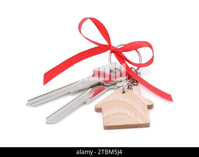 Clés avec porte-clés en forme de maison et arc rouge isolé sur blanc Banque D'Images