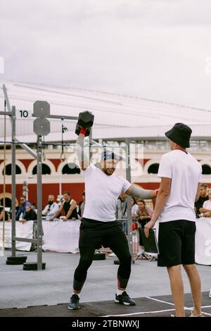 Compétition CrossFit pour Homme. Un homme soulève un haltère. Banque D'Images