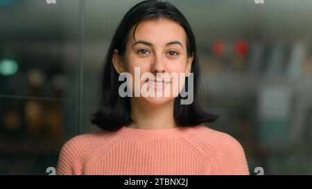 Portrait de la tête prise en gros plan femme caucasienne femme millennial employé du personnel d'affaires dans le bureau seul souriant regardant la caméra. Heureuse femme employeur Banque D'Images