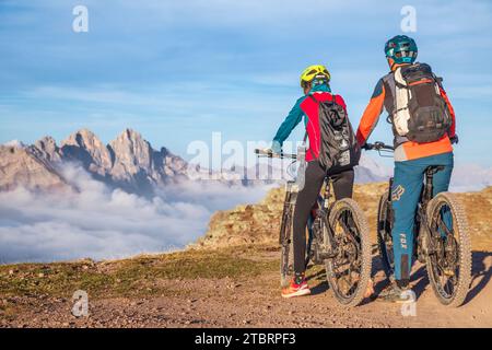 Italie, Vénétie, province de Belluno, Falcade, activités de plein air avec la famille, le père et la fille lors d'un tour en vélo électrique s'arrêtant pour admirer les montagnes au coucher du soleil Banque D'Images